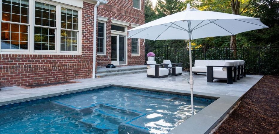 Small backyard pool with a patio seating area at a Northern Virginia home